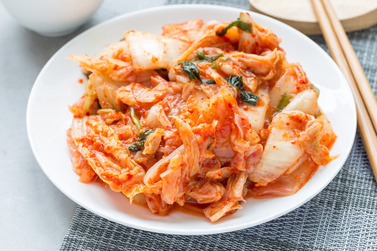 Kimchi cabbage. Korean appetizer on white plate, horizontal