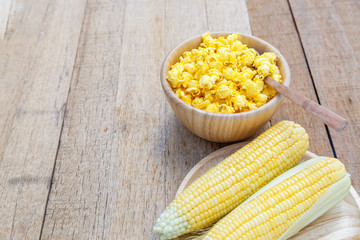 Popcorn cheese salty taste color yellow on wood blow on wooden table with copy space.