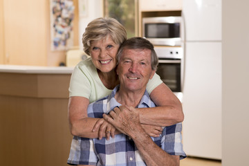 senior beautiful middle age couple around 70 years old smiling happy together at home kitchen looking sweet in lifetime husband and wife concept