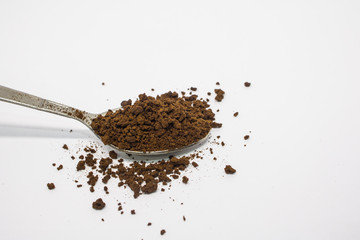 spoon with coffee powder on white background.
