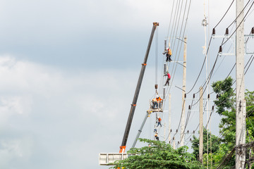 Asian men engineering working on high voltage workfield at countryside