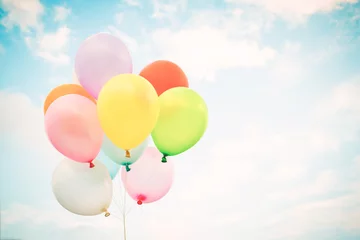  Vintage multicolor balloons with done with a retro instagram filter effect on blue sky. Ideas for the background of love in summer and valentine, wedding honeymoon concept. © jakkapan