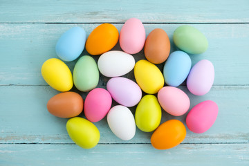 Fototapeta na wymiar Colorful Easter eggs on rustic wooden planks background. Holiday in spring season. vintage pastel color tone. top view composition.