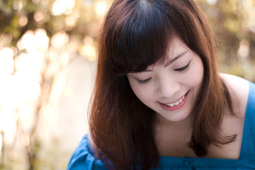 Close up of young pretty Asian woman in the garden.