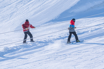People are having fun in downhill skiing and snowboarding