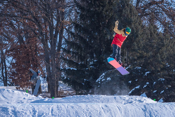 People are having fun in downhill skiing and snowboarding