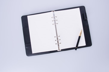 diary or notebook with pen on the background.