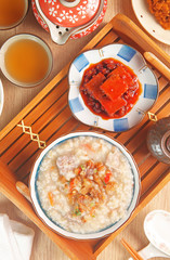 Brown rice porridge served with side dish. 