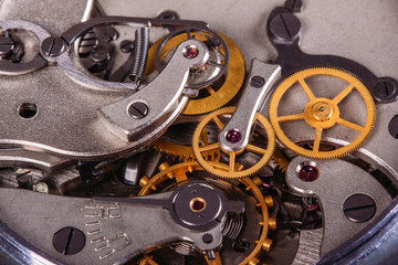 Open clock mechanism with gears and a spring