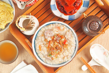 Brown rice porridge served with side dish. 