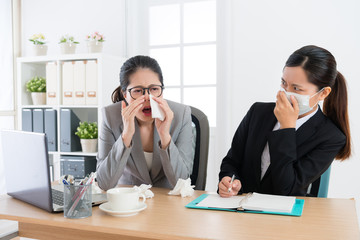 office worker woman sneezing during conference