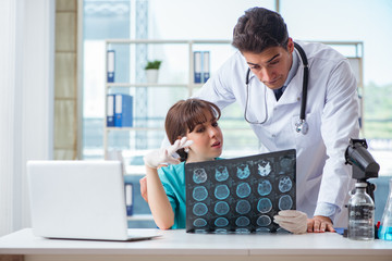 Two doctors discussing x-ray MRI image in hospital