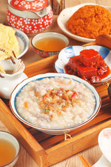 Brown rice porridge served with side dish.
