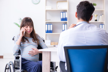 Fototapeta premium Pregnant woman visiting doctor for consultation