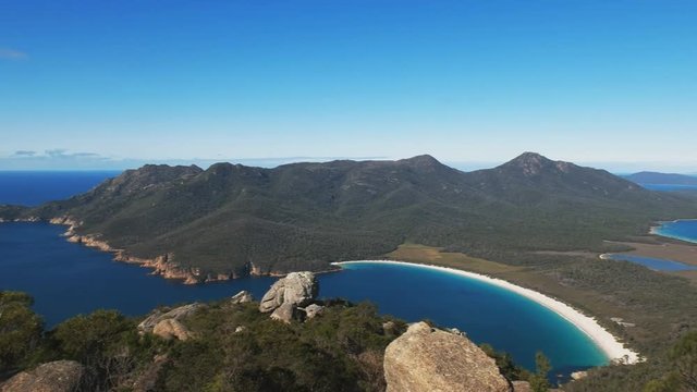 panning shot of wineglass bay from mt amos in freycinet national park on the east coast of tasmania, australia