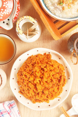 Dried shredded pork (or pork floss) with tea and gruel  on wooden table     