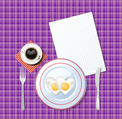 heart shaped scrambled eggs and cup of coffee on violet tablecloth