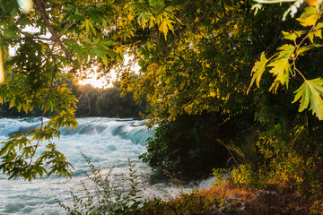 Small waterfall on the river during sunset