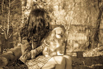 Nice friendly woman with her dog on a walk at sunny spring day 