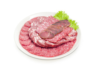 Sliced different salami and other meat products on white dish