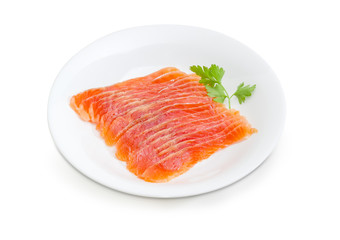 Sliced salted fillet of salmon on a white dish