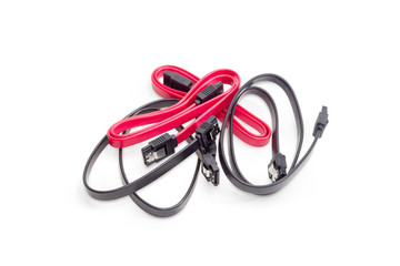 Red and black cables for computers technology on white background