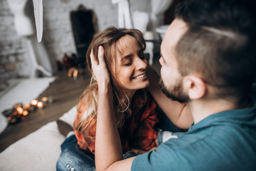 Naklejka premium Husband gently touched his wife's hair, and the wife laughs. Love story