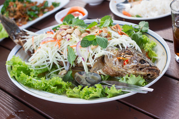striped snakehead fish salad in restaurant
