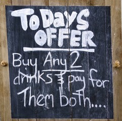 A novelty sign mounted outside a bar         