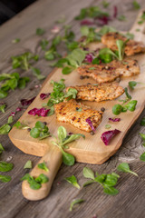 Fresh freshly fried delicious slices of meat on a wooden board with fresh herbs. Appetizing steaks on a wooden board. Still life.