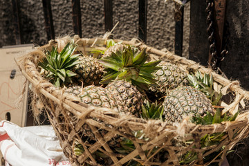 Heap pineapples in straw basket market stone town, Tanzania, Zanzibar