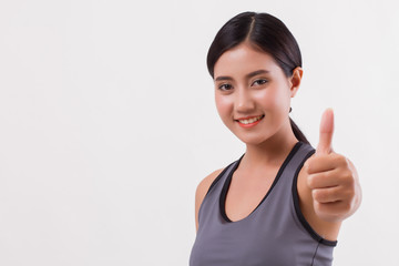 confident happy smiling fitness woman giving thumb up