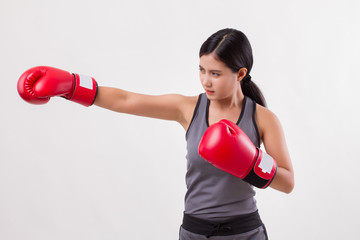 strong fitness woman punching isolated