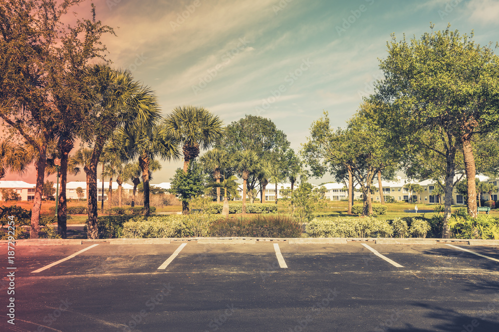 Wall mural Gated community empty parking lot  in South Florida. Light effect applied