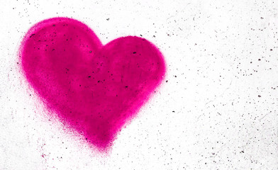 Pink heart on concrete wall