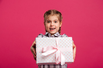 Happy little girl child holding gift box surprise.