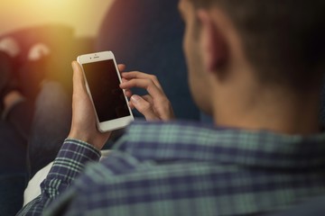 young man on the couch with the mobile phone