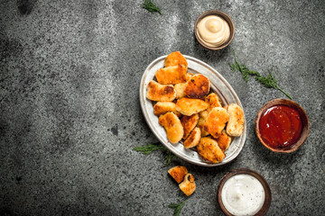 Fototapeta premium Chicken nuggets with various sauces.