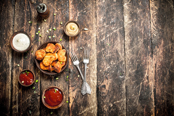 Chicken nuggets with various sauces.