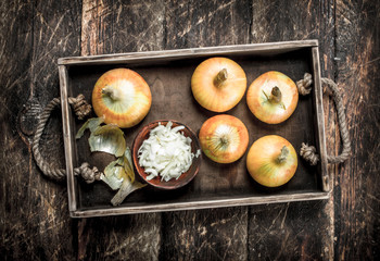 Sliced onions in an old tray.