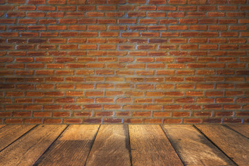 empty room with red brick wall and wooden floor
