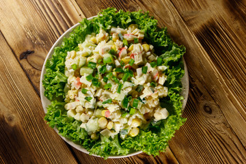 Salad with crab sticks, sweet corn, cucumber, eggs, rice and mayonnaise