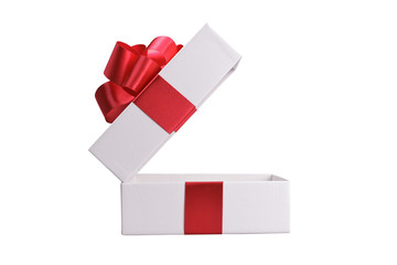 White gift box with red ribbon. Isolated