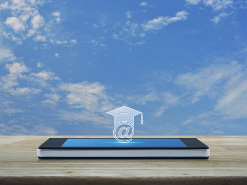 e-learning icon on modern smart phone screen on wooden table over blue sky with white clouds, Study online concept