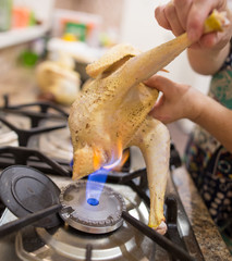 The cook cuts the chicken on fire