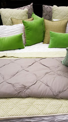 Cushions, pillows and throws on a bed interior design