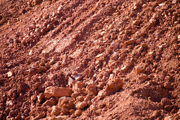 Red clay soil on nature as a background