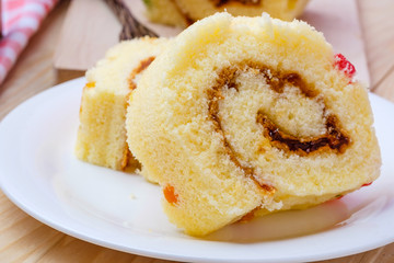 Sliced Cake Roll on wooden background
