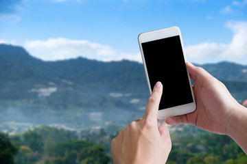 Smartphone on hands with touch screen on empty display on natural view on background.