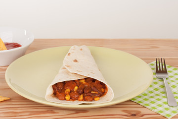 Chili Con Carne on tortilla wrap with salsa sauce and tortilla chips
